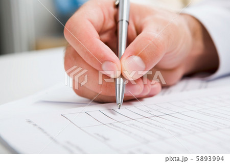Male’s hand writing in the document Male’s hand writing in the document 5893994