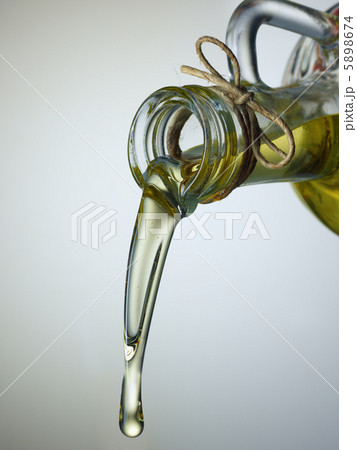 Olive Oil pouring from a bottle Olive Oil pouring from a bottle 5898674