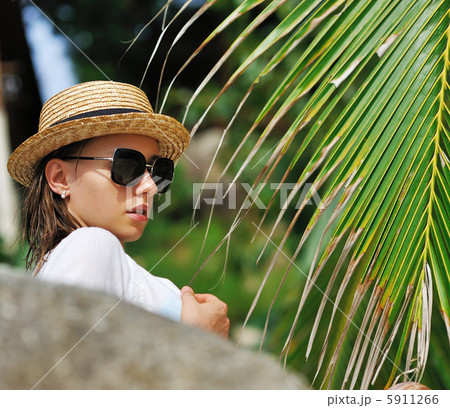 Woman in sunglasses near palm tree Woman in sunglasses near palm tree 5911266