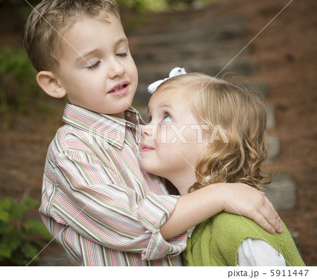 Adorable Brother and Sister Children Hugging Outside 5911447