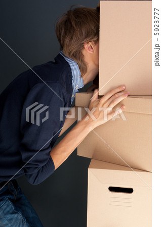 Portrait of anonymous young man with his head inside box 5923777