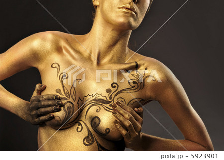 Portrait of young sexy woman in golden paint 5923901