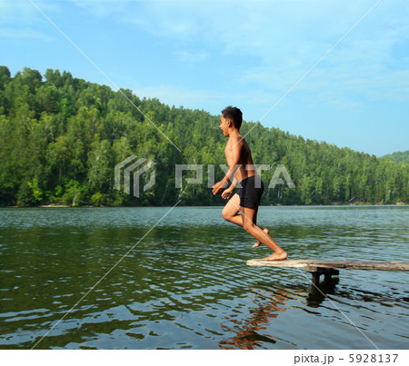 boy jumping in lake 5928137