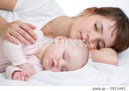Young mother and her baby sleeping together 5953465