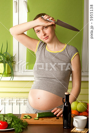 pregnant woman on kitchen with knife 5955138