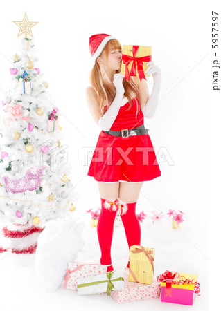 クリスマスプレゼントにキスをするセクシーなサンタさんの写真素材