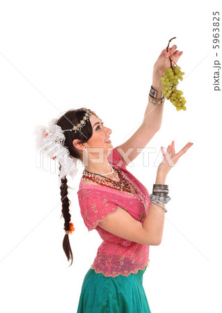Young girl in the Indian national dress with grape 5963825