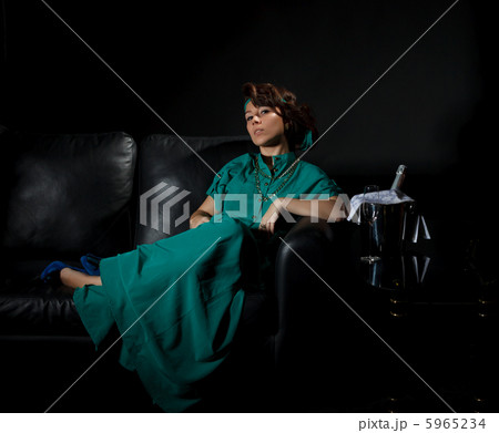 Beautiful girl sitting on a sofa 5965234