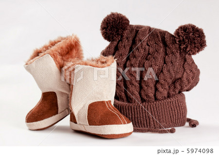 child winter boots and cap on a white background child winter boots and cap on a white background 5974098