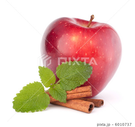Red apple, cinnamon sticks and mint leaves still life 6010737