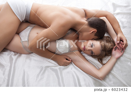 Young lovers lay in bed - only lingerie 6023432