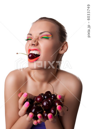Funny girl eat ripe cherry isolated 6033749