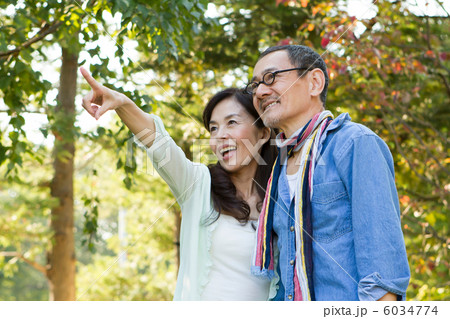 緑の中を散策するシニア夫婦 6034774