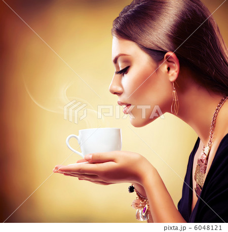 Coffee. Beautiful Girl Drinking Tea or Coffee 6048121