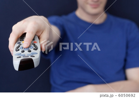 Guy watching tv with remote 6050692