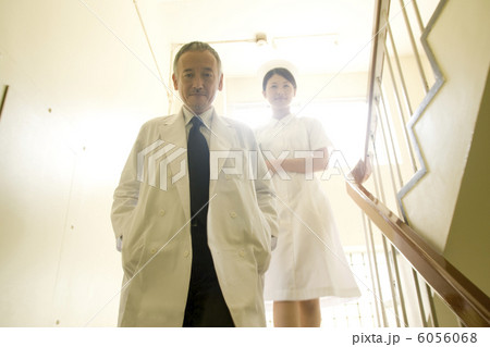 階段を降りる男性医師と女性看護師 6056068