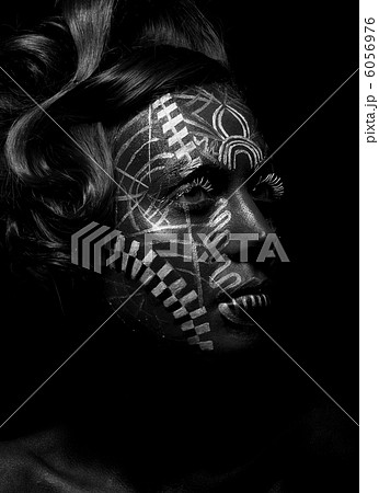 Savage religious woman voodoo, tattoo. Tribe. Painted face 6056976