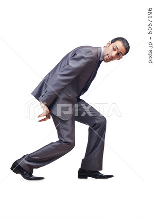 Young businessman pushing invisible obstacles Young businessman pushing invisible obstacles 6067196