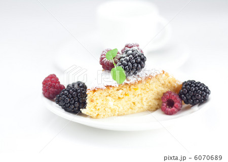 cup, cake, raspberry, blackberry,nuts and mint on a plate on a w 6070689