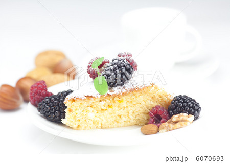 cup, cake, raspberry, blackberry,nuts and mint on a plate on a w 6070693