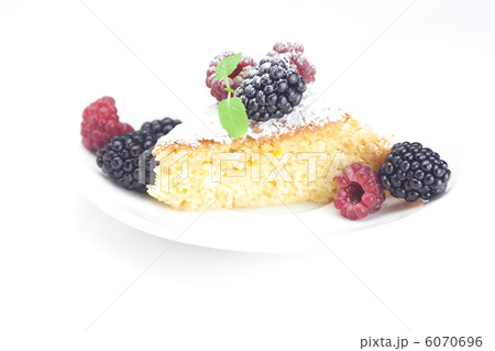 cup, cake, raspberry, blackberry,nuts and mint on a plate on a w 6070696