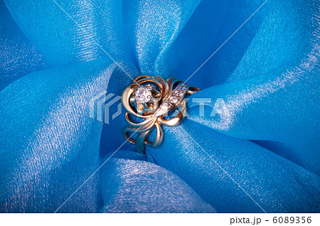 Golden jewelry ring on blue background Golden jewelry ring on blue background 6089356