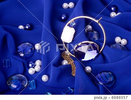 Golden jewelry on blue background Golden jewelry on blue background 6089357