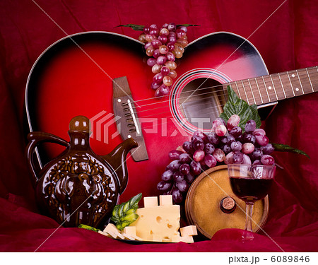 Beautiful composition with wine, grape, cheese and guitar on red background Beautiful composition with wine, grape, cheese and guitar on red background 6089846