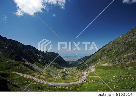 Empty road surrounded by mountains 6103614