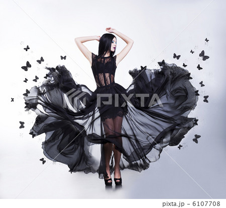 Swing. Sensual Woman in Black Fluttering Dress with Butterflies 6107708