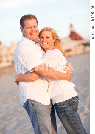 Attractive Caucasian Couple Hugging at the Beach 6110950