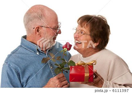 Happy Senior Couple with Gift and Red Rose Happy Senior Couple with Gift and Red Rose 6111397
