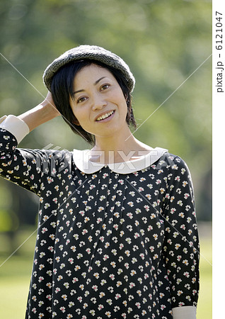 帽子を押さえる女性の写真素材