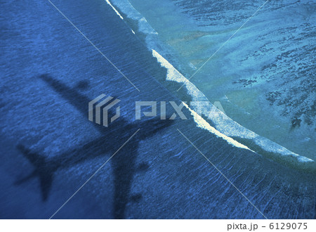 海に写る飛行機のシルエット 6129075