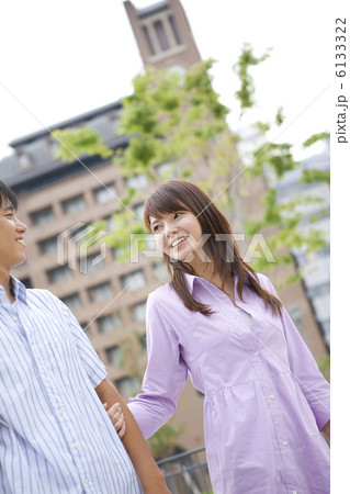 男性の腕を掴んで歩く女性 6133322