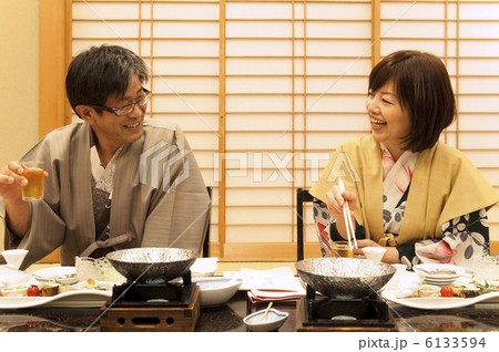 浴衣を着て食事する中高年夫婦 6133594