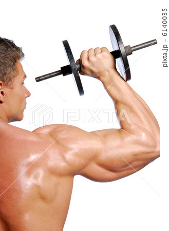 man with muscular body lifts a dumbbell 6140035