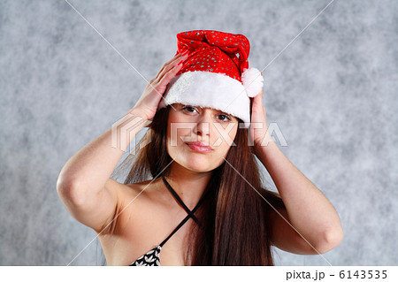 Young sexy Santa in bikini isolated on grey Young sexy Santa in bikini isolated on grey 6143535