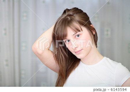 A Relaxed Young Woman Smiling With Hand On Chin 6143594