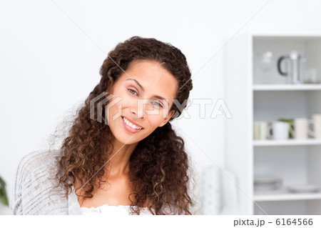 Portrait of a pretty woman standing in her kitchen 6164566