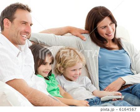 Parents and children watching television together 6164567