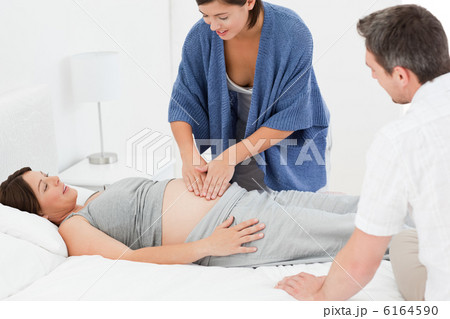 Pregnant woman with her husband and a nurse Pregnant woman with her husband and a nurse 6164590