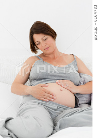 Pregnant woman cuddling her belly 6164783