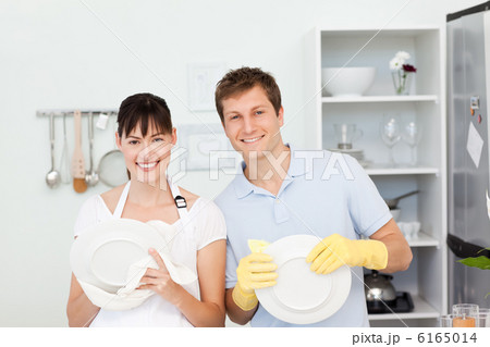 Lovers washing dishes together 6165014
