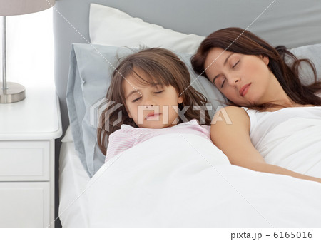 Cute little girl sleeping with her mother in the morning 6165016