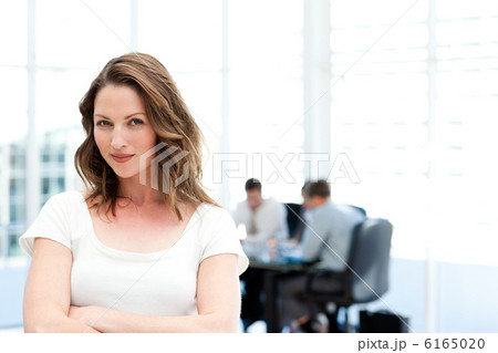 Beautiful businesswoman standing in front of her team while work Beautiful businesswoman standing in front of her team while work 6165020