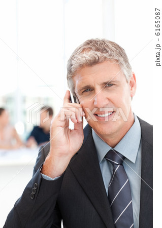 Businessman phoning while his team is working 6165087