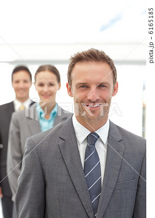 Three happy business people posing in a row 6165185