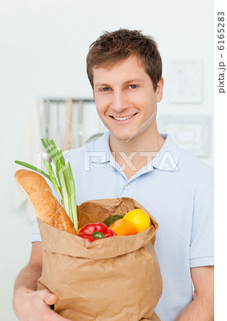 Man with shoping bags in the kitchen 6165283