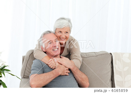Lovers hugging while they are looking at the camera Lovers hugging while they are looking at the camera 6165859
